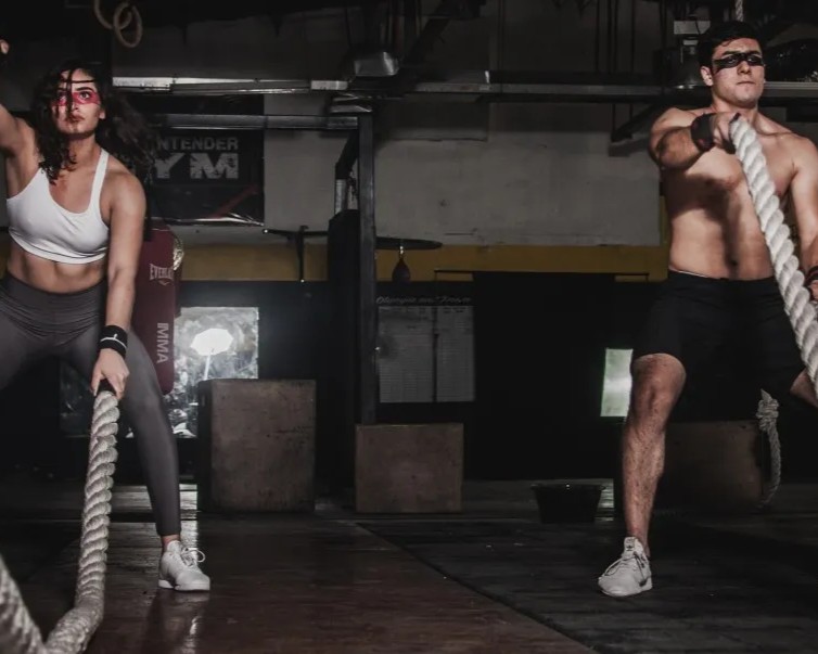 A couple training intensely after receiving Testosterone Replacement Therapy - Injections from Encompass Wellness & Aesthetics. 