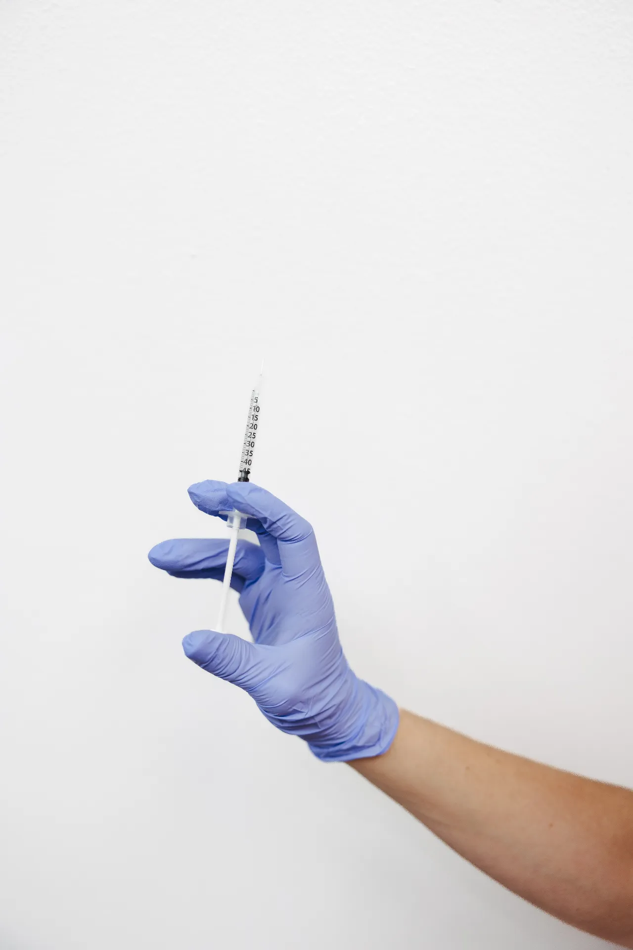 Encompass Wellness provider holding a prepared syringe during the OMG-Shot PRP injection process