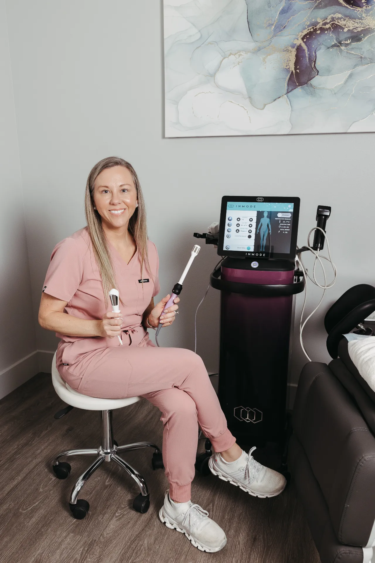 Encompass Wellness provider holding Vtone and FormaV devices for women's health intimate wellness services